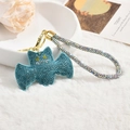 Detail of blue rhinestone bat keychain with sparkling wristlet on plush background - Rope Style Blue