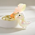 Dettaglio del portachiavi dinosauro iridescente con cinturino in silicone sfumato - Bianco