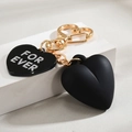 Detail of black heart keychain with golden ring and For Ever engraving - Black
