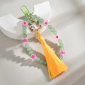 Detail of beaded peach keychain with cat moon pendant and long yellow silk tassel - Dark Green