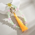 Detail of handmade beaded charm with green beads, floral accents and a cat pendant - Light Green