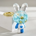 Blue acrylic rabbit keychain with liquid pearls and lucky heart on white display pedestal - Rabbit Style / Blue