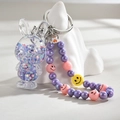 Macro view of transparent acrylic bunny keychain with colorful glitter and beaded chain - Purple (Rabbit Chain)