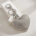 Detail of silver heart rhinestone keychain with a white tassel and lobster clasp - White with Silver Flower Buckle