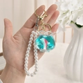 Ocean floating bottle keychain with pink dolphin charm and elegant pearl strap - Fish Tank Shape - Pearl Chain & Buckle Style
