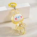 Gros plan d'un mignon pendentif lapin jaune translucide avec finition brillante et fermoir - Porte-clés + Lapin Dansant / Anneau de couleur jaune citron
