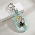 Handmade Tree of Life glass pendant keychain with real dried flowers and blue glitter cord - Blue