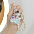 Detail of floating liquid milk carton keychain with astronaut bunny and pearl chain - Milk Carton Astronaut