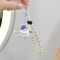 Astronaut keychain in UFO capsule with blue floating oil and white pearl wrist strap - UFO Astronaut