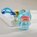 Detailed close-up of a blue glowing frog doll keychain with a cool strap and golden bell - Blue