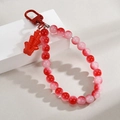 Detail of red beaded keychain with bamboo charm and metallic D-ring buckle accessory - Firecrackers