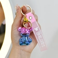 Colorful gradient bear keychain with pink silicone wrist strap and golden bell charm - Pink