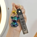 Close-up of electroplated gradient bear keychain with golden bell and PVC wrist strap - Gray