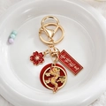 Detail of Year of the Dragon keychain with gold dragon charm and good luck pendant - Success in Exams