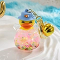 Cartoon yellow duck liquid keychain with glitter stars and gold bell in a glass ball - Fish Tank Shaped