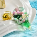 Detail of acrylic ice cream keychain with floating beads, green liquid and gold bell accessory - Green