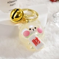 Detailed shot of a pearlescent bear charm with a golden bell and lucky red character - Light Gold Clasp + Fortune Bear + Bell / White