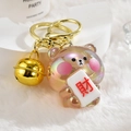 Detailed macro of jelly bear keychain with golden bell and mahjong coin on white plush - Light Gold Clasp + Fortune Bear + Bell / Brown