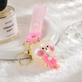 Detail of pearlescent bear keychain holding pink strawberry ice cream on a white tray - Bear strap + Luminous Bear / Light Pink