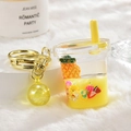 Creative fruit tea cup acrylic keychain with floating strawberry and pineapple slices - Lemon Yellow