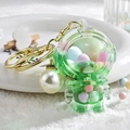Green astronaut acrylic liquid keychain with colorful beads and pearl charm - Astronaut Pearl Green
