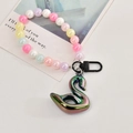 Close-up of a gradient swan pendant charm with pastel pearl beads and matte black hook - Buckle Chain With Swan / Black