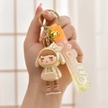 Close-up of cute girl keychain with golden bell and bubble patterned PVC strap - Gradient Strap + Girl + Bell / Off White