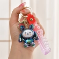 Close-up of a glowing acrylic bunny keychain with metallic gradient finish and wrist strap - Gray