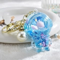 Creative blue liquid quicksand astronaut keychain with golden chain and pearl charm - Astronaut Pearl Blue