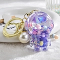 Purple astronaut keychain with liquid glitter sand and white pearl accessory on faux fur - Astronaut Pearl Purple