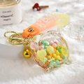 Cute liquid sand keychain featuring a pig-shaped acrylic bottle and colorful floating beads - Alarm Clock Lemon Yellow