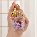 Purple astronaut quicksand keychain in alarm clock shape with golden bell and beads - Alarm Clock Bell Purple