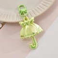 Macro detail of mint green iridescent umbrella pendant with heart wings and clip - Green