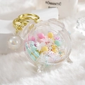Bell-shaped acrylic liquid keychain with pastel beads and gold hardware on white fur - Alarm Clock Beads White