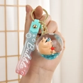 Detail of Capybara liquid quicksand keychain with blue sequins and soft rubber wrist strap - Peach Style / Gradient Strap + Oil Infused Bottle