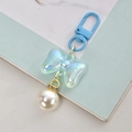 Sweet light blue bow pendant with pearl charm and golden rhinestone ring on books - Blue With Pearl