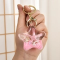 Star-shaped acrylic liquid keychain with pink glitter, shells and golden clasp - Marine Series (Pink) / Pink