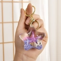 Star-shaped acrylic keychain with blue sand, sea star, and golden ring accessory - Marine Series (Purple) / Purple