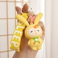 Close-up of yellow bunny keychain with carrot hoodie and SLEEPY strap detail - Carrot Rabbit (SLEEPY Wristband) / Lemon Yellow