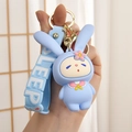 Cute blue rabbit silicone keychain with sleep strap held in hand for size display - Closed Eye Rabbit (SLEEP Wristband) / Blue