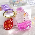 Pink liquid sand acrylic keychain with floating white rabbit and golden metal ring - Bunny Soda Bottle / Purple