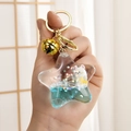 Portachiavi a stella con sabbia liquida, orsetto bianco e paillettes blu lucide - Pentagramma