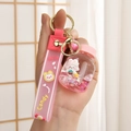 Detail of pink liquid shaker keychain featuring a cute rabbit figurine and glitter bottle - Soda Bottle