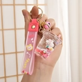 Pink liquid strawberry bunny keychain with silicone hand strap and gold keyring bell - Milk Tea Cup