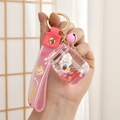 Pink liquid bottle keychain with bunny and strawberry inside, including a matching strap - Tea Cup