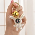 Luminous pearlescent white astronaut rabbit keychain with a golden bell and starry helmet - White (Bell Style)