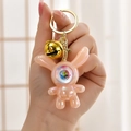 Pink pearlescent astronaut rabbit keychain with gold bell and colorful earth detail - Bean Paste Pink (Bell Style)