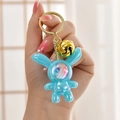 Luminous blue astronaut bunny keychain with iridescent finish and golden bell - Blue (Bell Style)