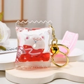 Detail of candy bag keychain with liquid glitter, bear donut, and pink wrist strap - Bear Strap + Pillow Donut / Red