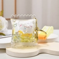 Macro shot of liquid keychain with candy bag design and white bear donut floatie - Bear Strap + Pillow Donut / Lemon Yellow